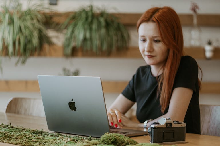 Redhead Woman Sitting with Laptop